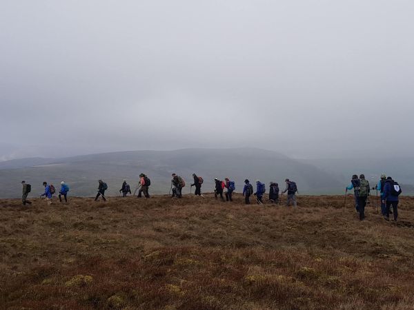 Ramblers on a misty ridge walk